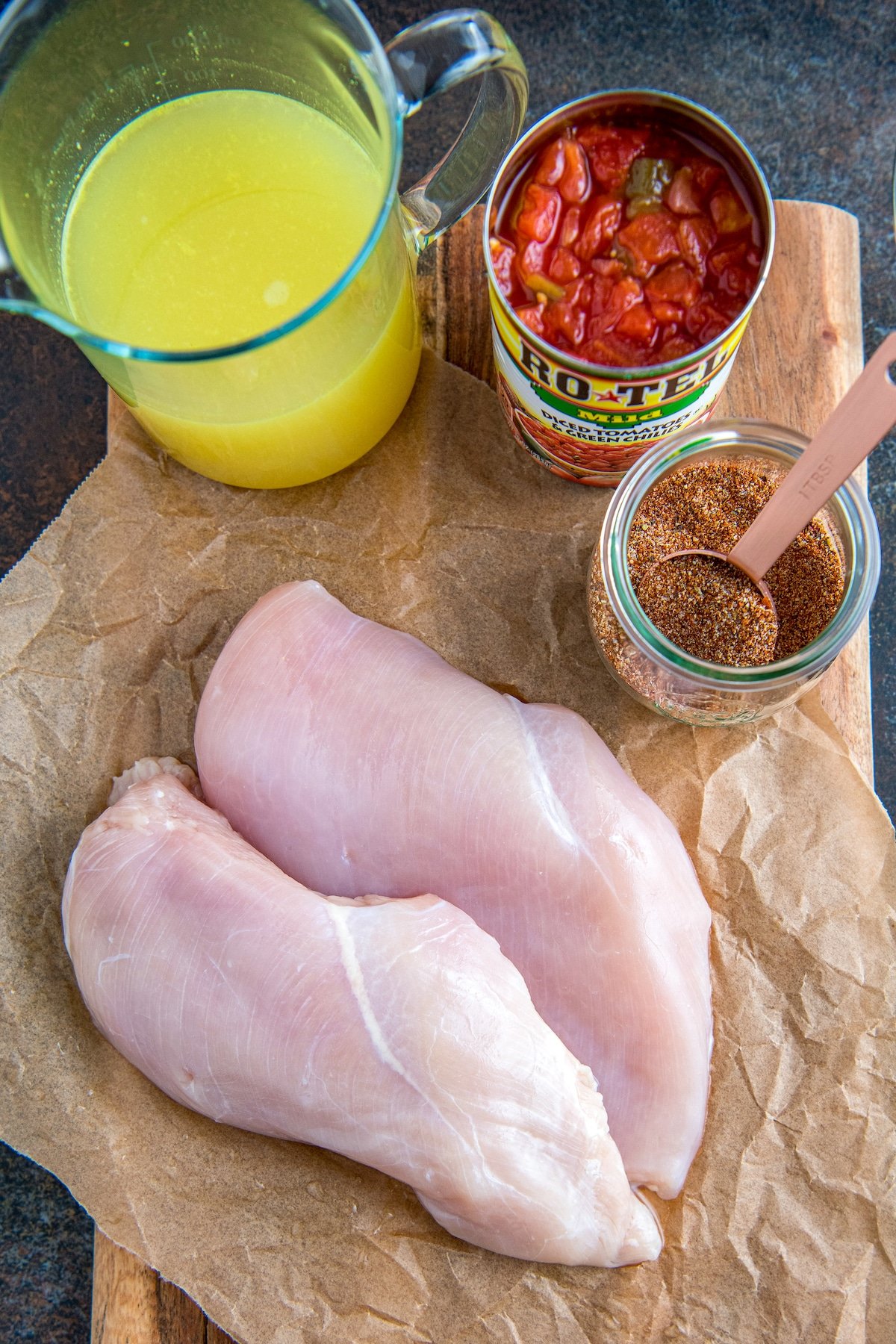 Ingredients for salsa chicken on parchment paper.
