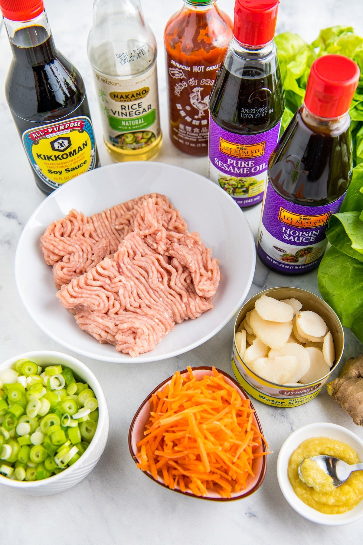 Ingredients for chicken lettuce wraps in bowls.