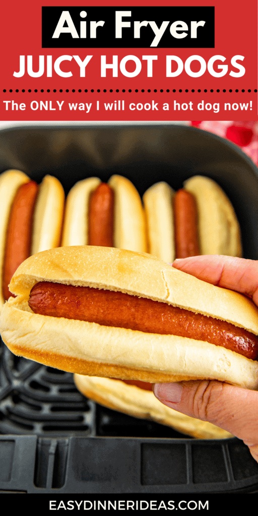 Hot dog being held by a hand over an air fryer basket.