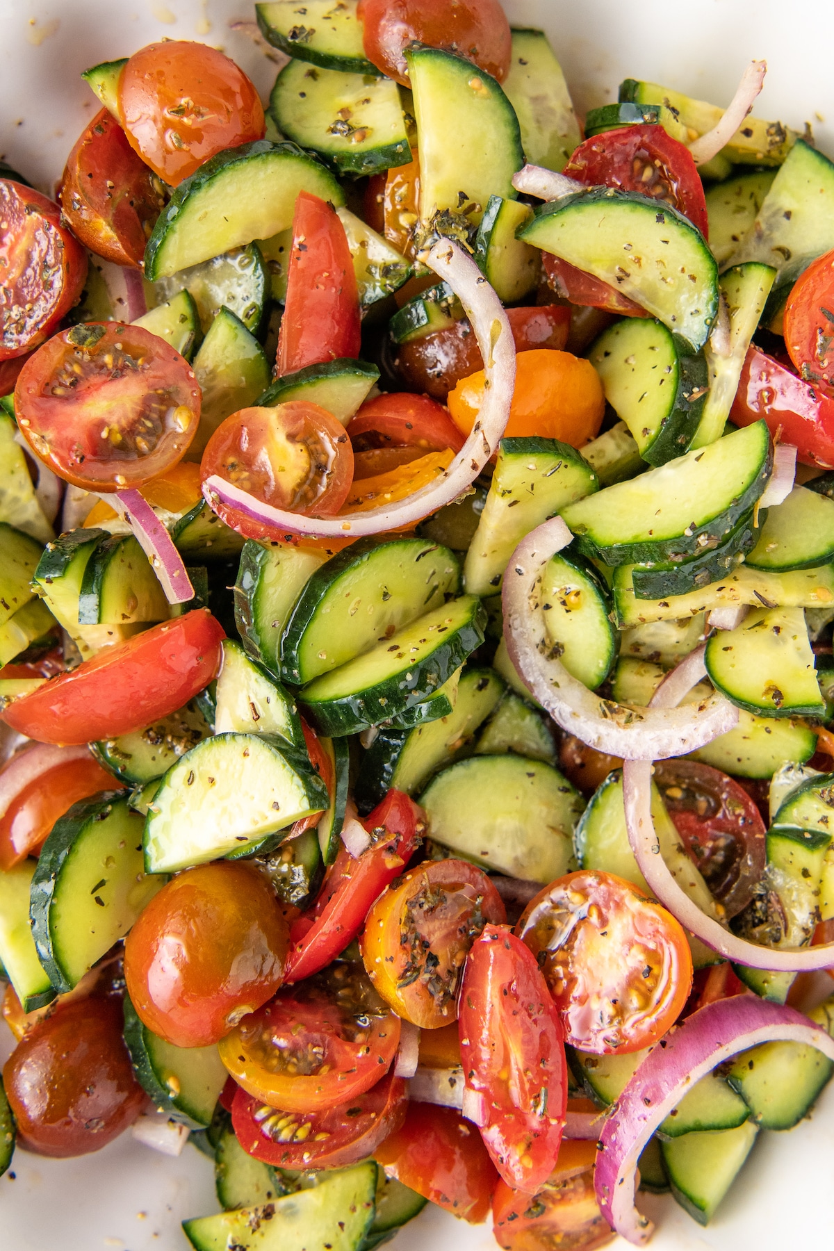 Tomato Cucumber Salad in a large white glass bowl.