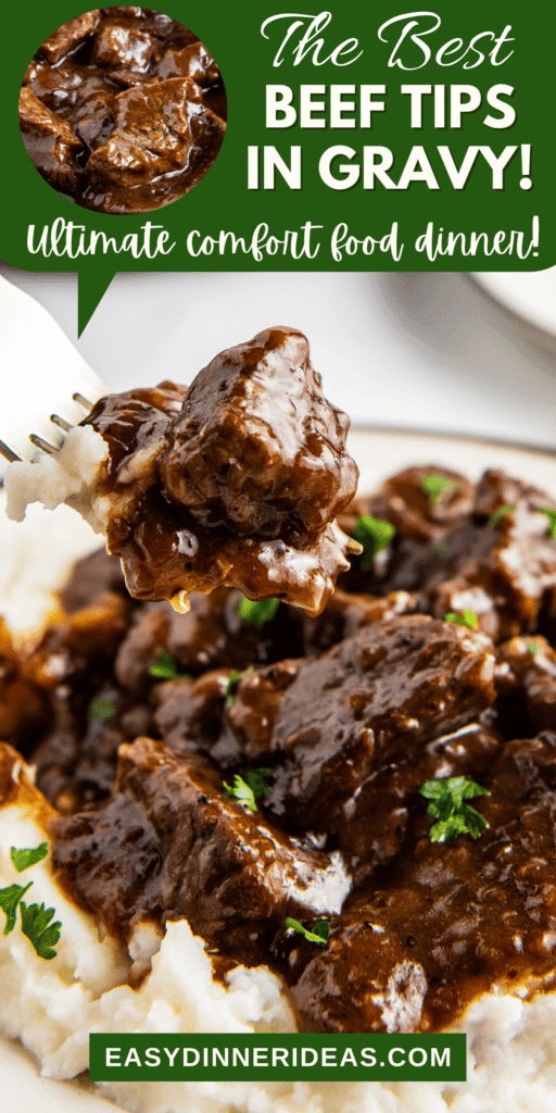 A fork lifting a bite of beef from a plate of beef tips in gravy on mashed potatoes.