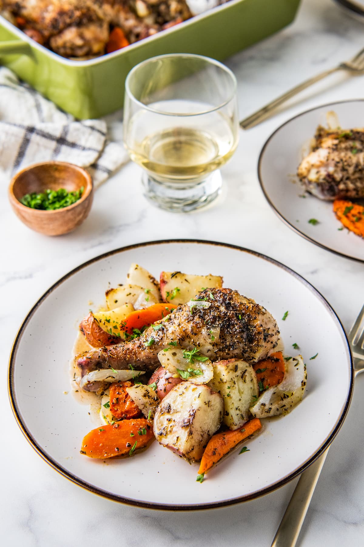 Plate with cooked chicken legs and vegetables