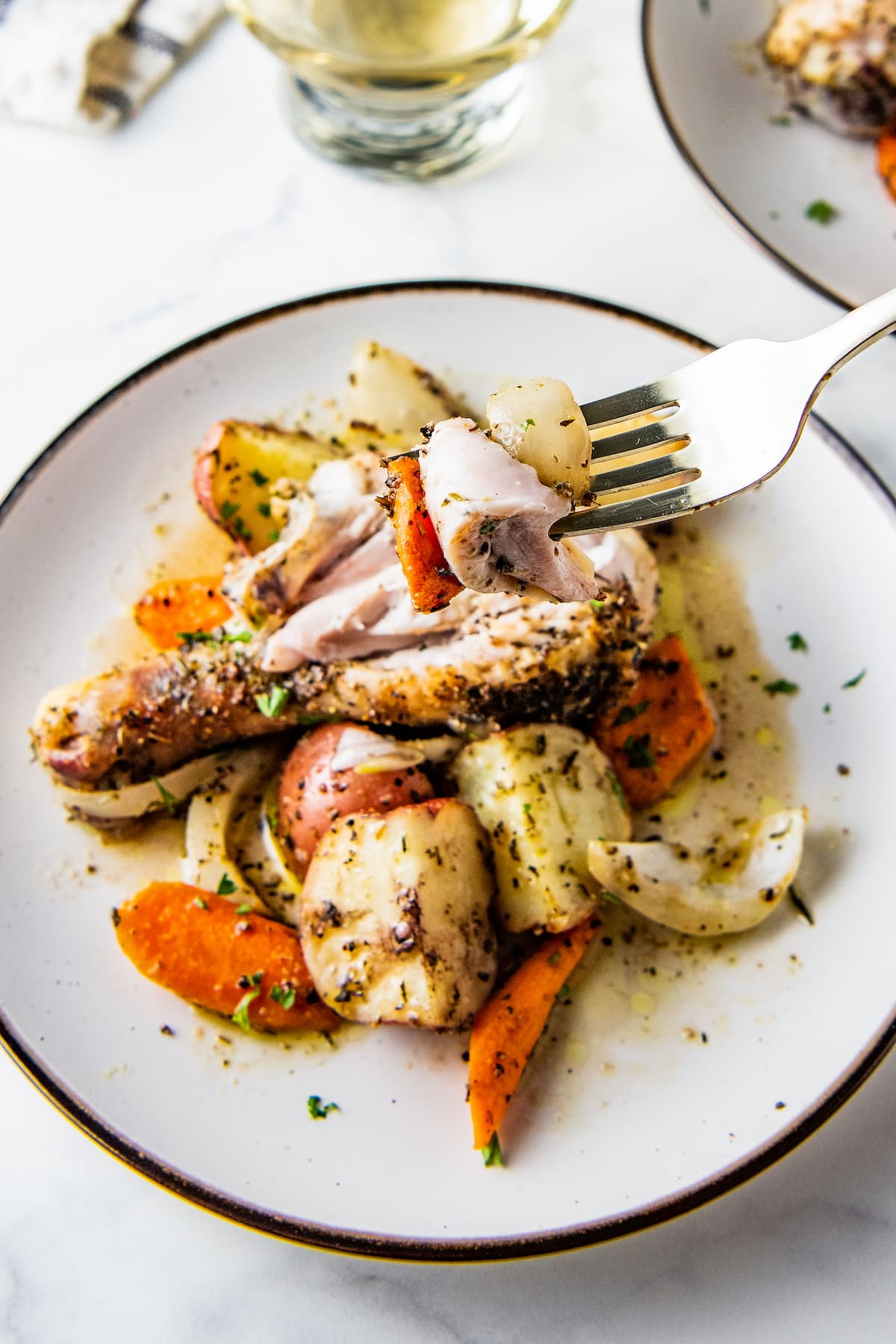 Plate with cooked chicken legs and vegetables