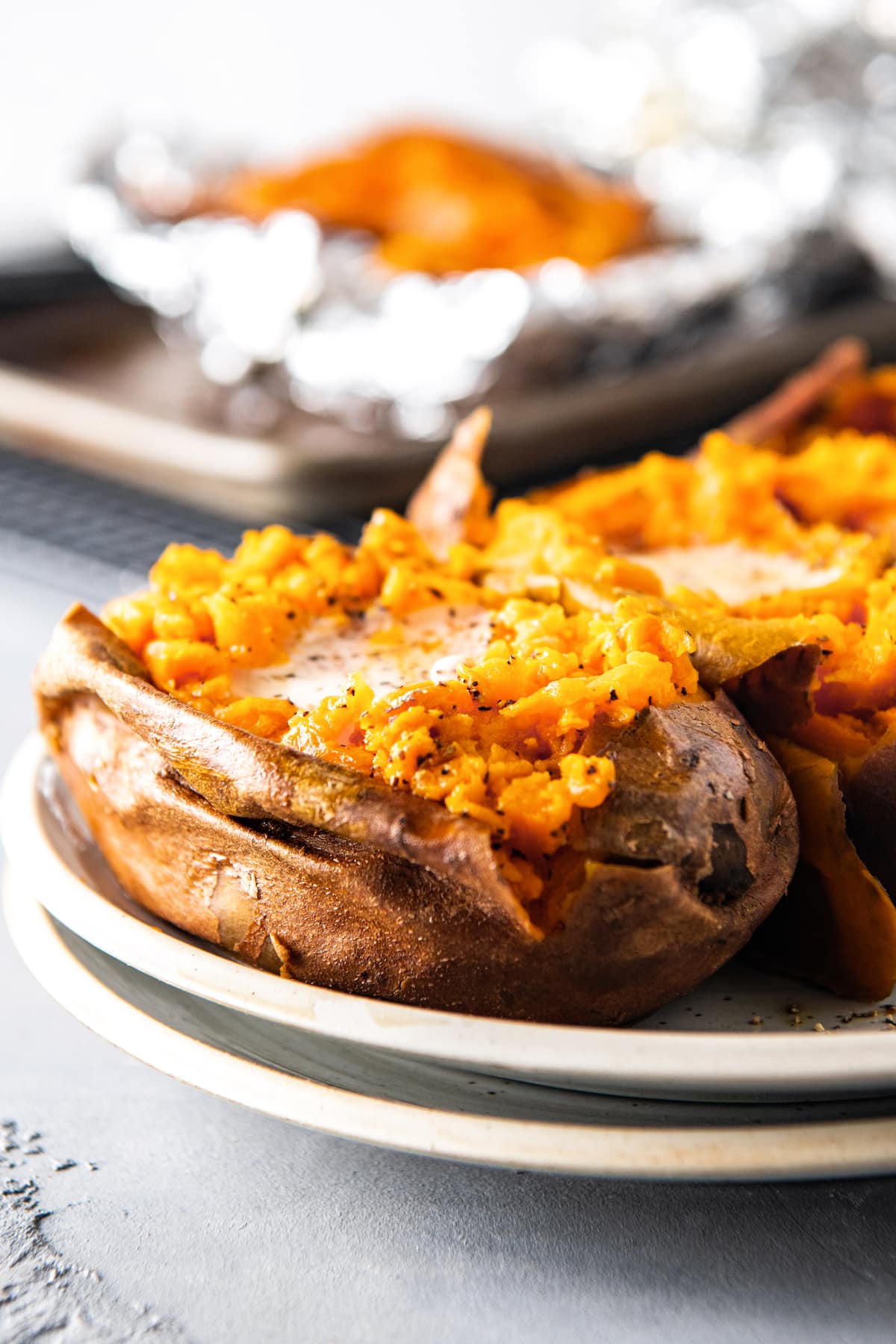 baked sweet potato with butter on a plate