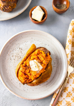 baked sweet potato with butter on a plate