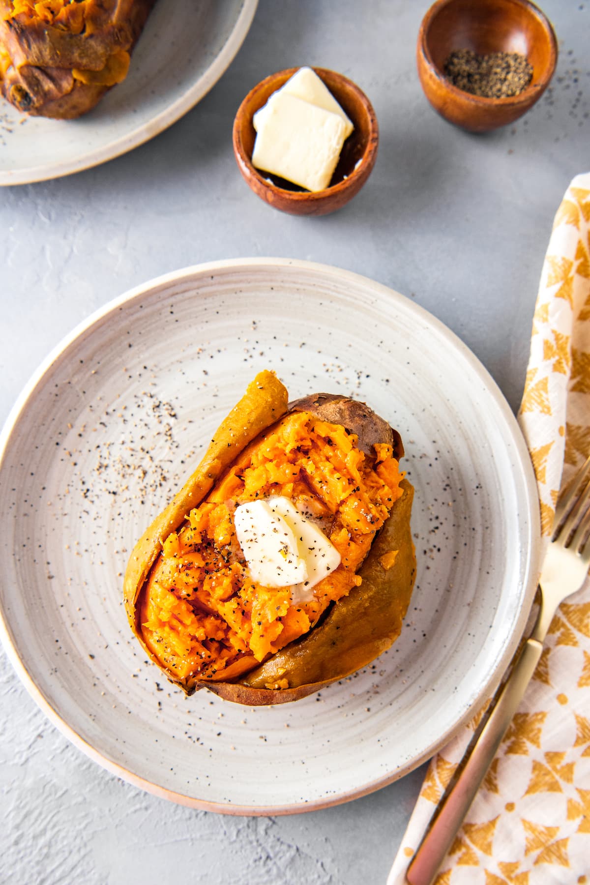 baked sweet potato with butter on a plate