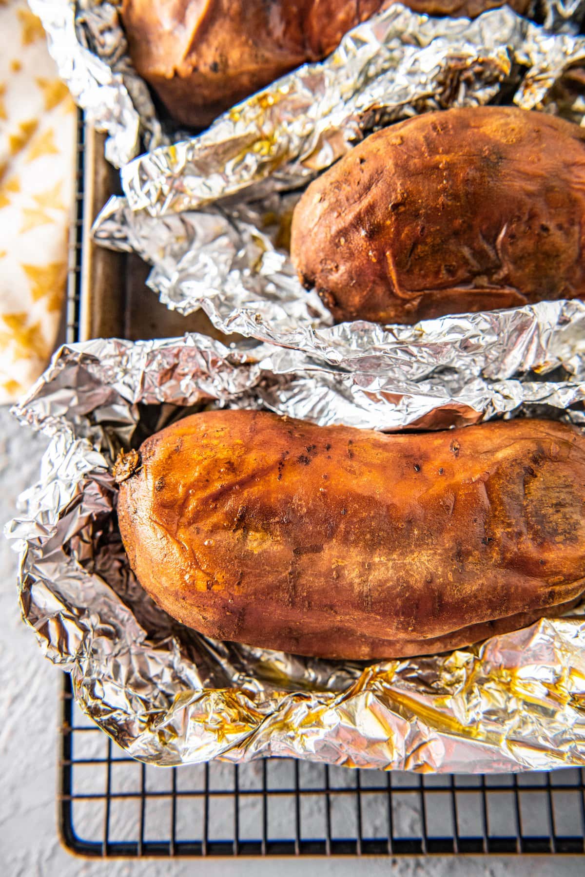 whole baked sweet potato wrapped in foil