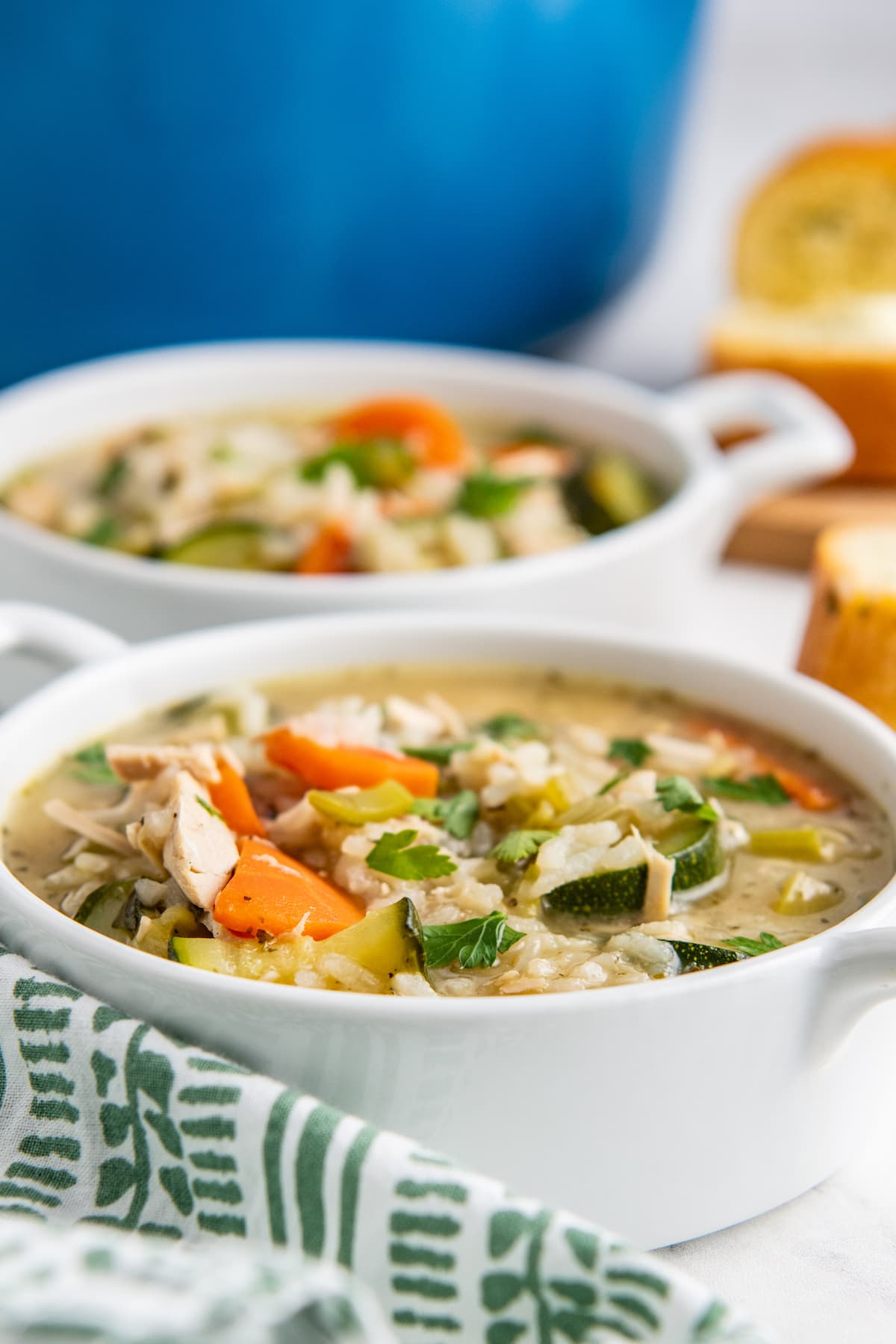 two bowls of chicken and vegetable soup