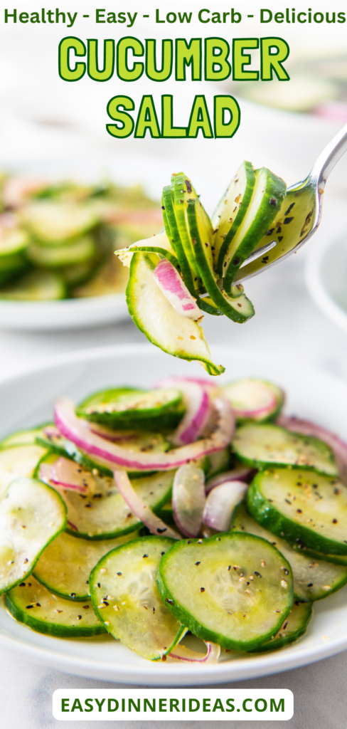 A fork picking up a bite of cucumber salad off a plate.