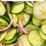 Thinly sliced cucumbers and onions tossed in a vinaigrette.