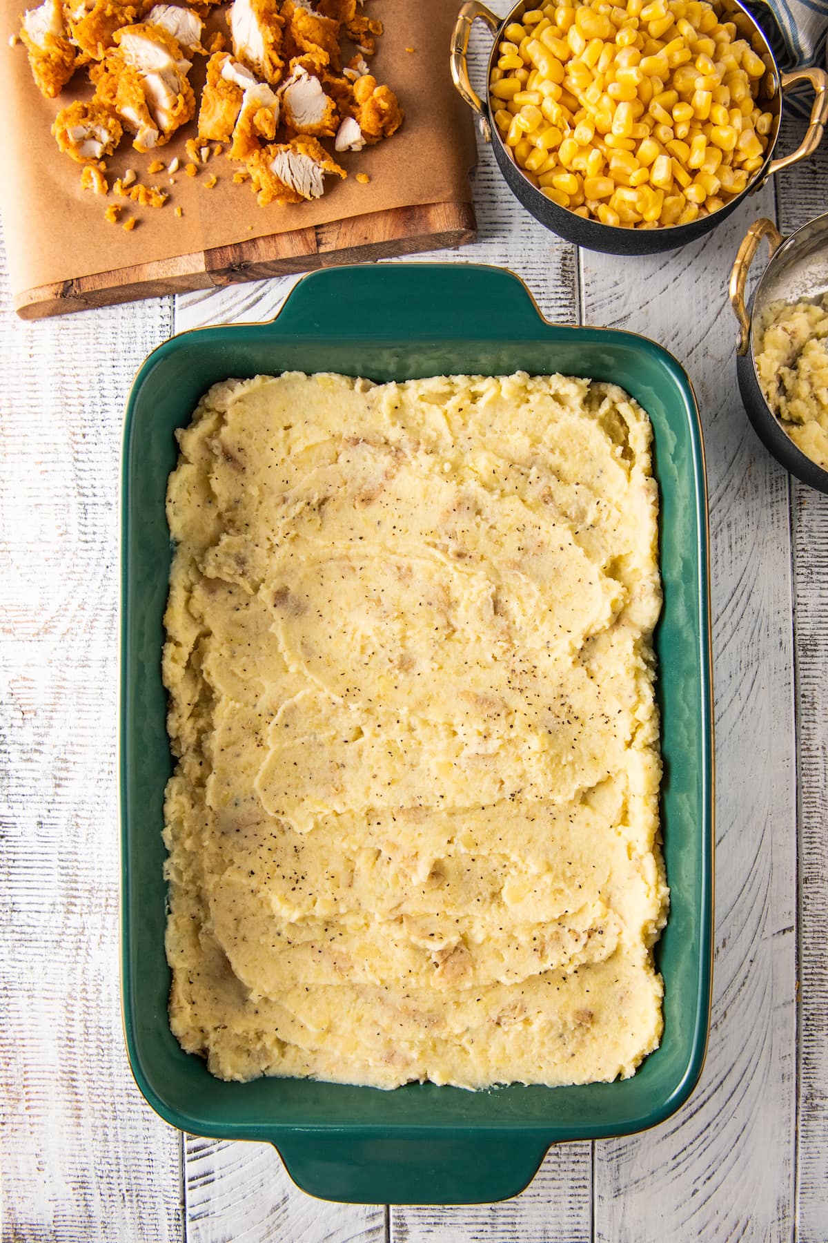 a large baking dish with mashed potatoes spread into it