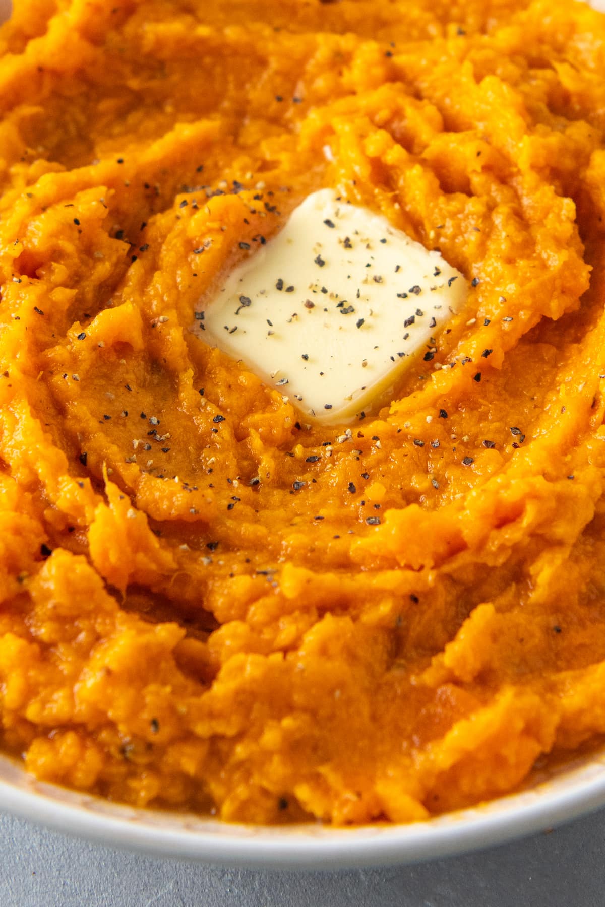 mashed sweet potatoes with a pad of butter in the middle