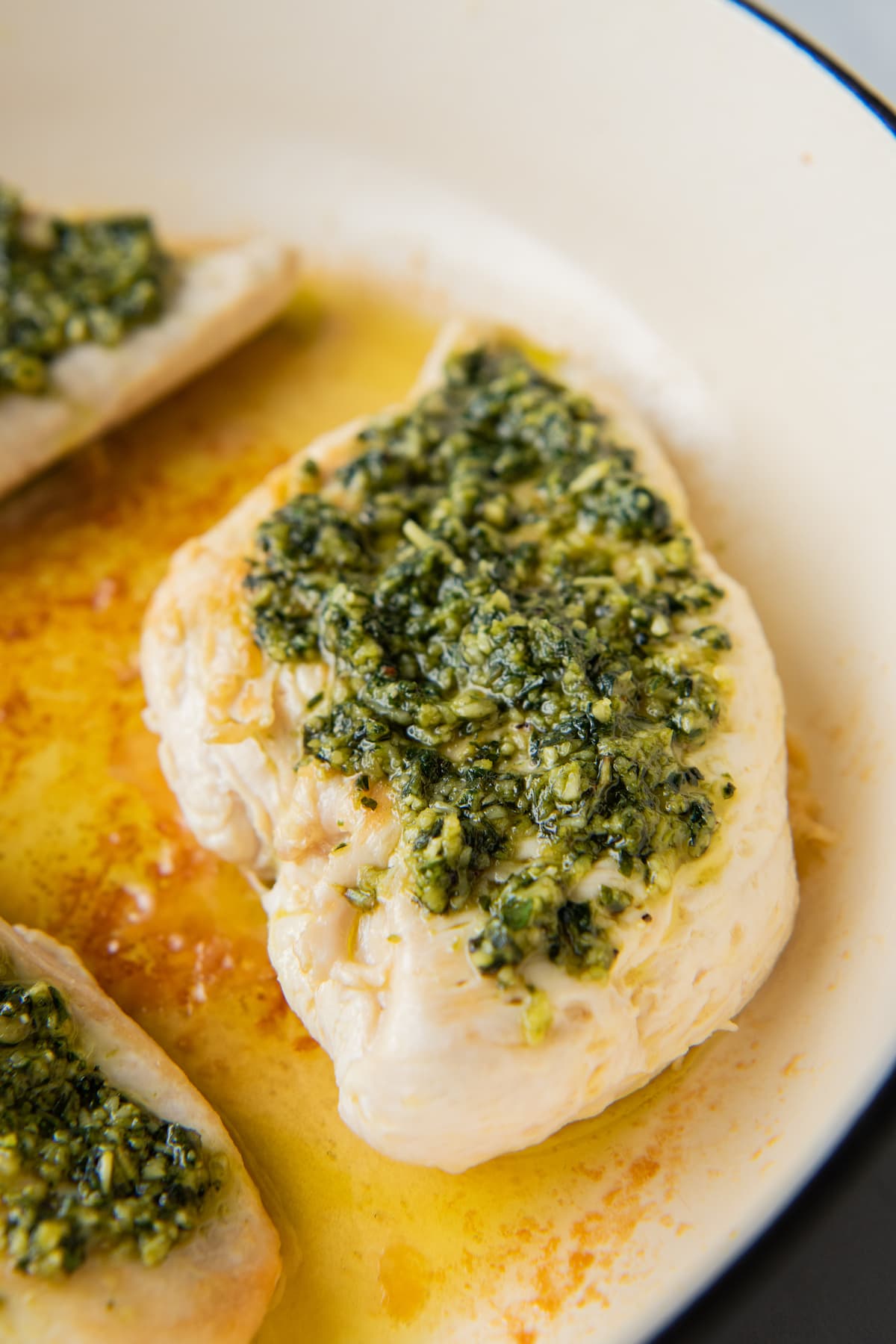cooked chicken breast with pesto on top