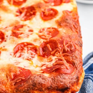 close up of pizza being baked in a casserole dish