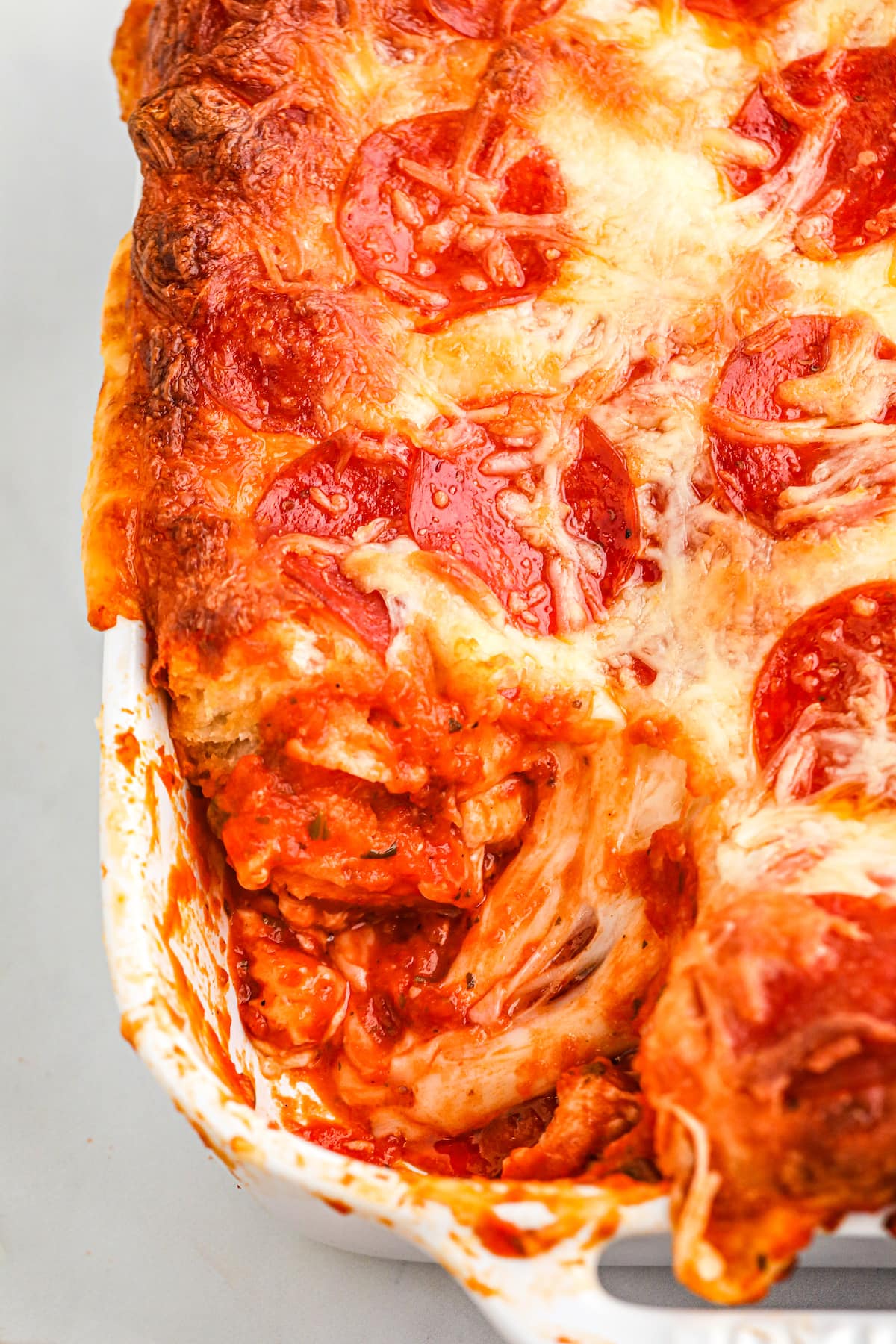 close up of pizza being baked in a casserole dish