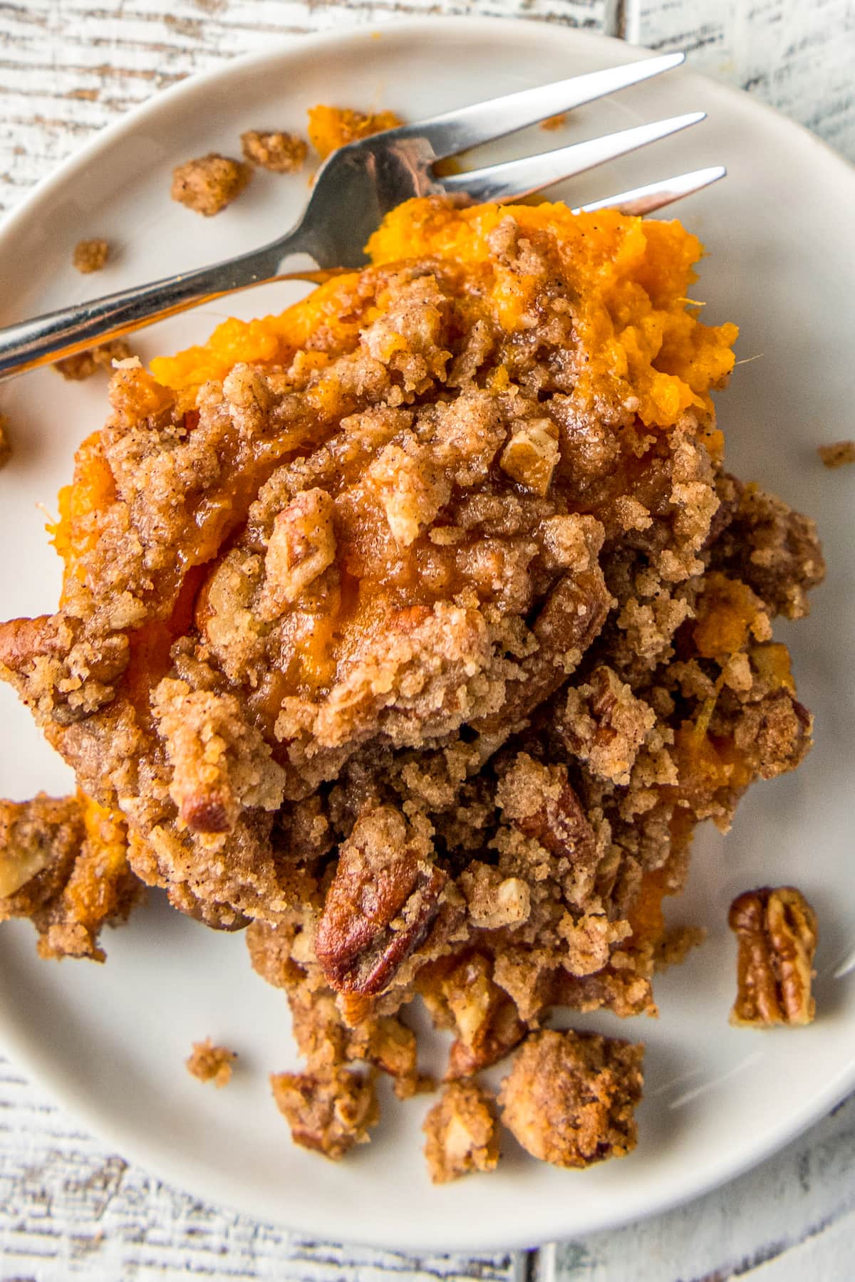 a scoop of sweet potato soufflé with brown sugar and pecan topping