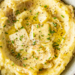 Close up of a bowl of mashed potatoes.