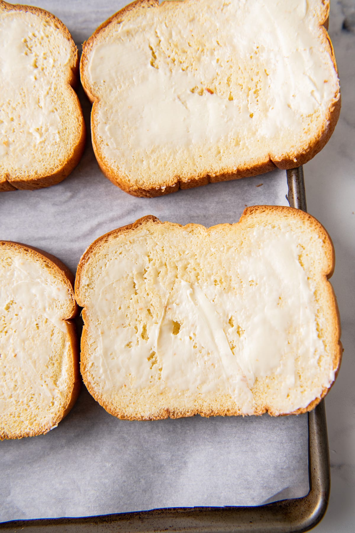 sliced bread with butter spread on it outside