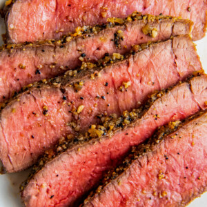 sliced medium-rare steak that's heavily seasoned