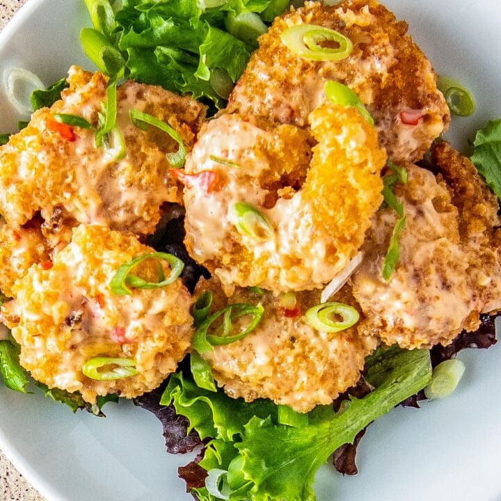 Fried bang bang shrimp with sauce on salad greens