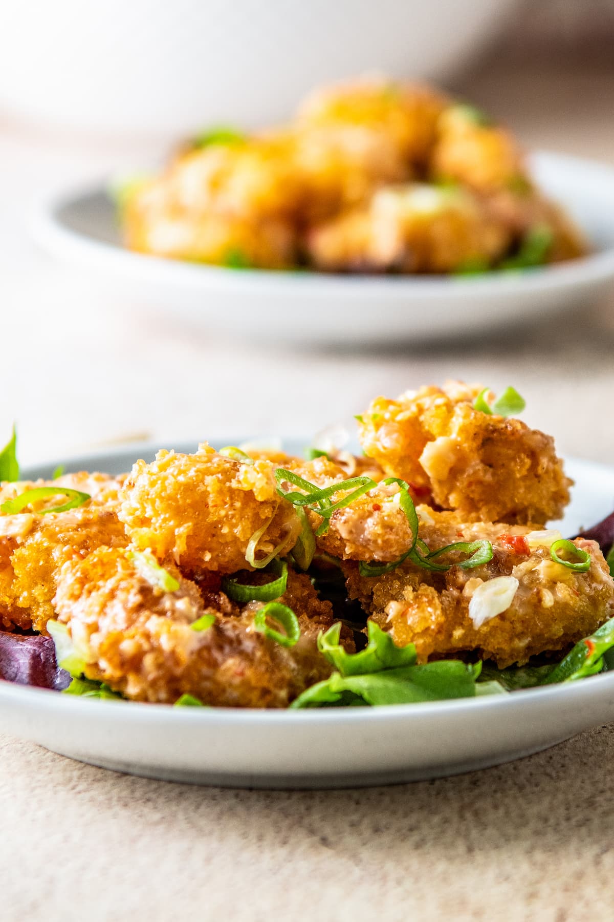 Fried bang bang shrimp with sauce on salad greens