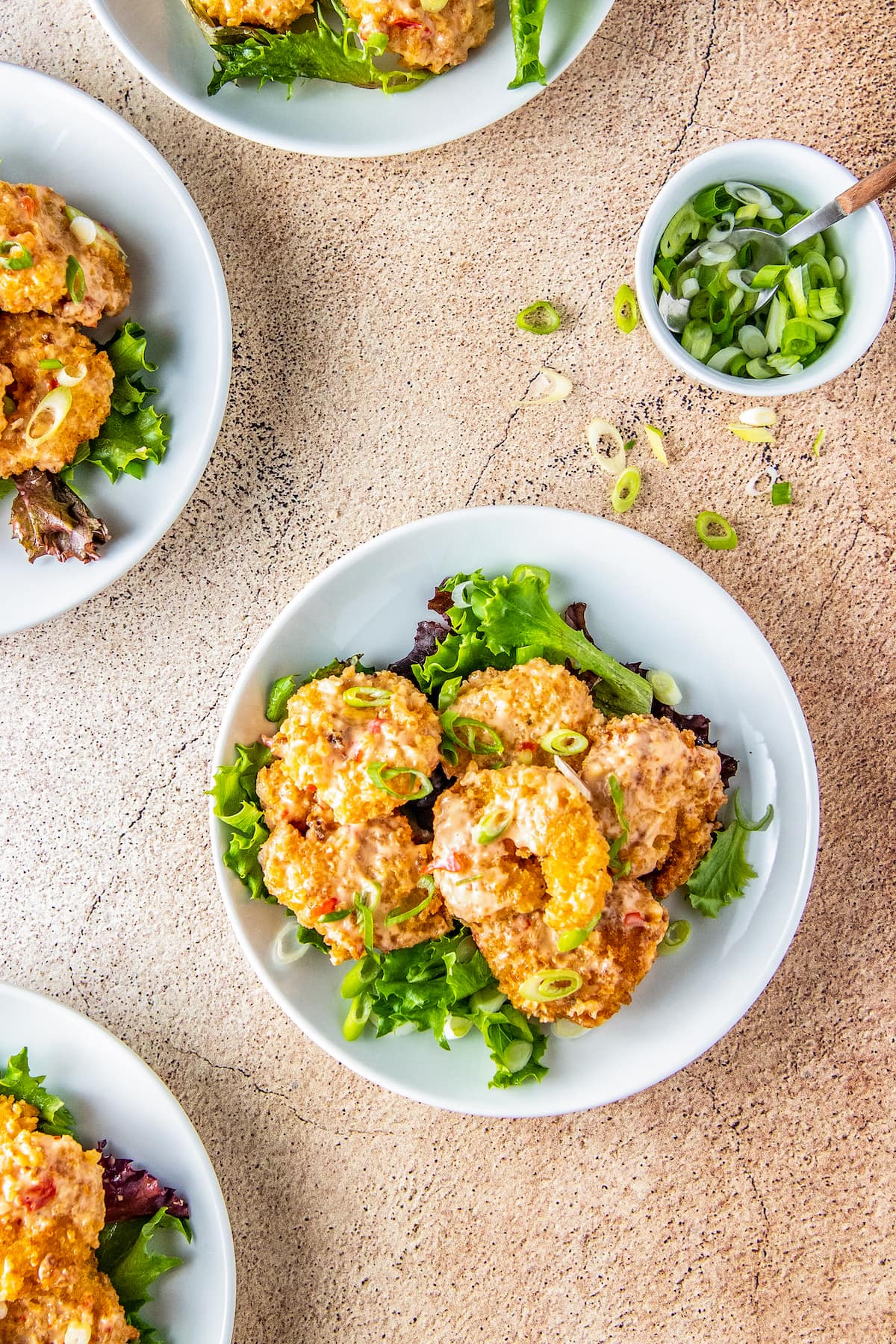 Fried bang bang shrimp with sauce on salad greens