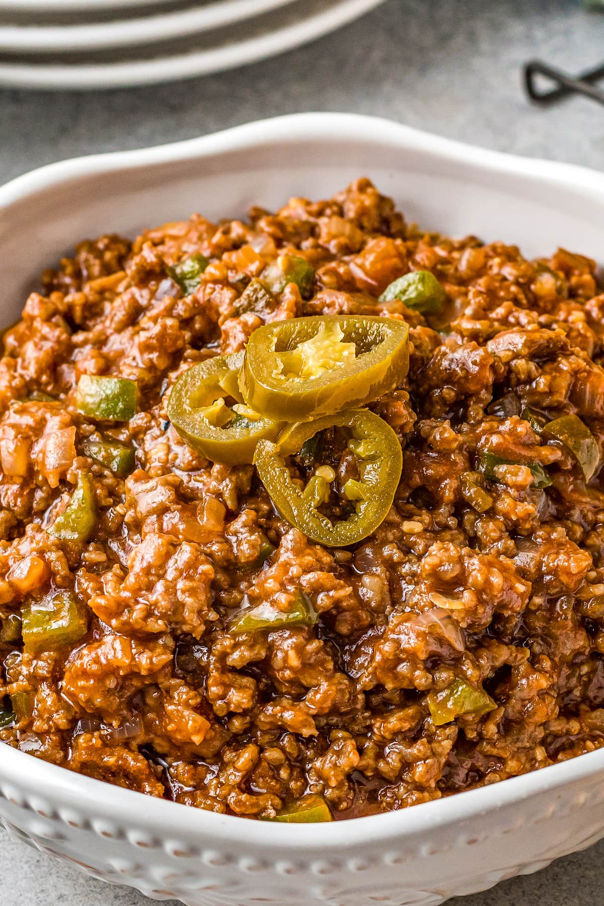 sloppy joe mix in a small casserole dish with pickled jalapeno on top