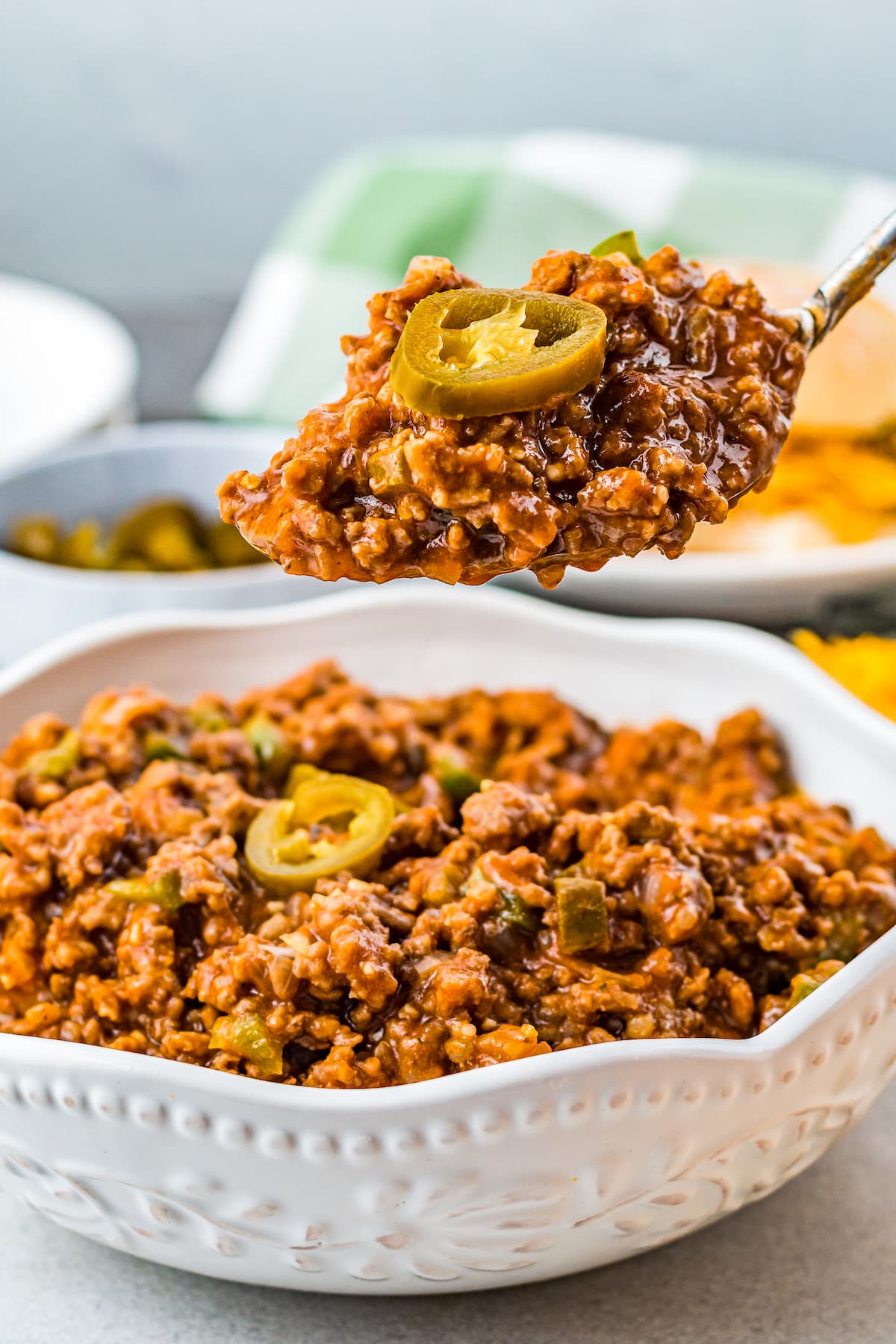 sloppy joe mix in a small casserole dish with pickled jalapeno on top