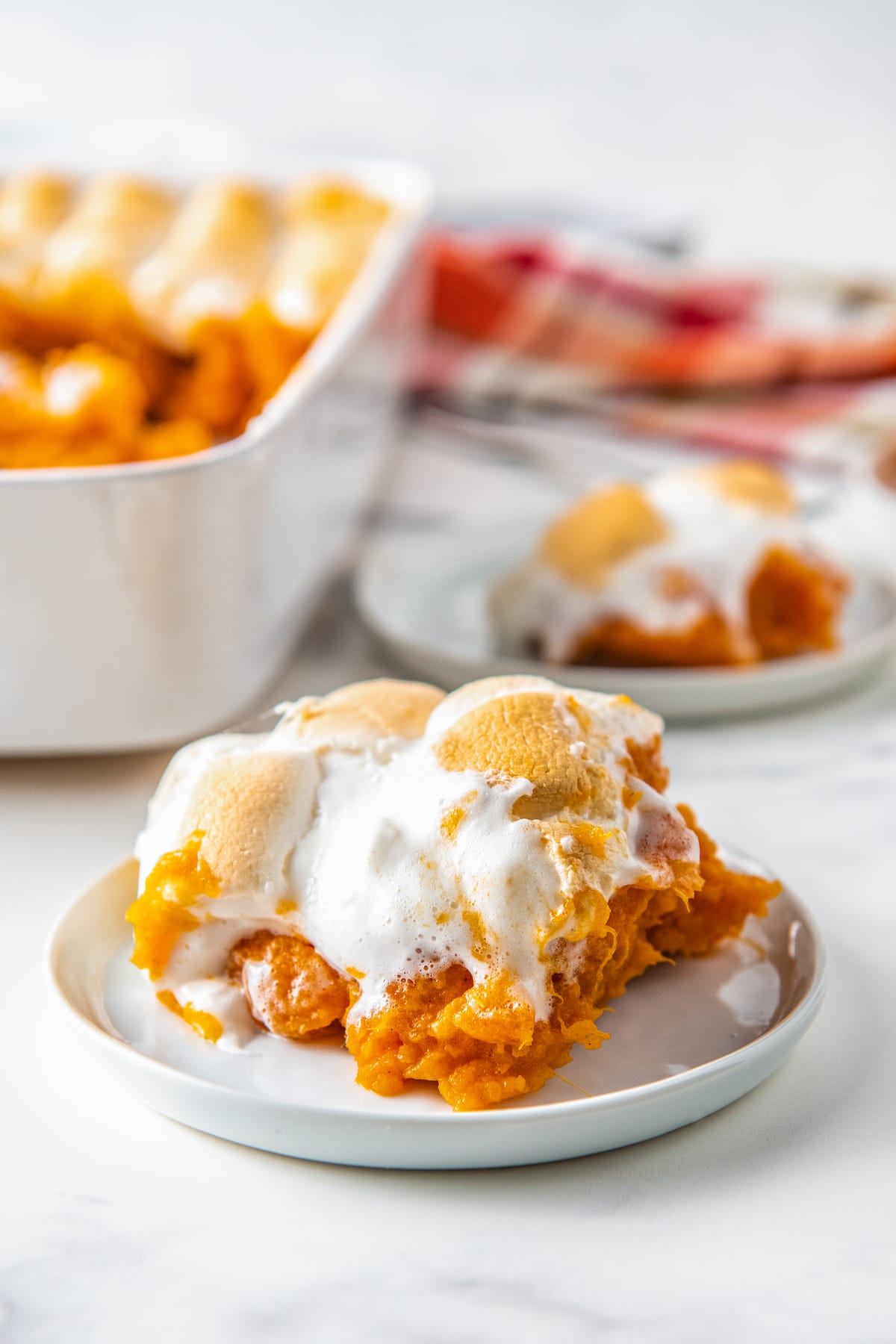 a portion of sweet potato casserole with marshmallows on a plate
