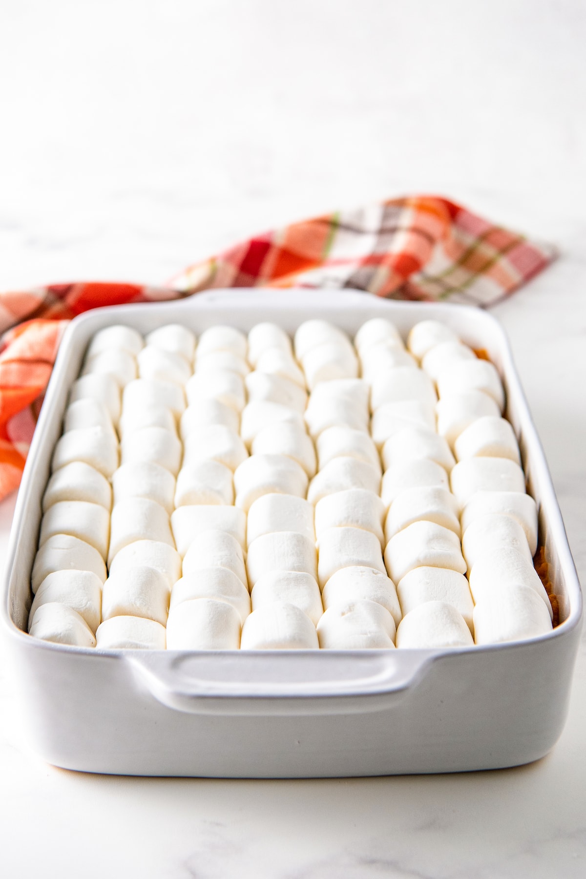 marshmallows laying flat on a caserole dish