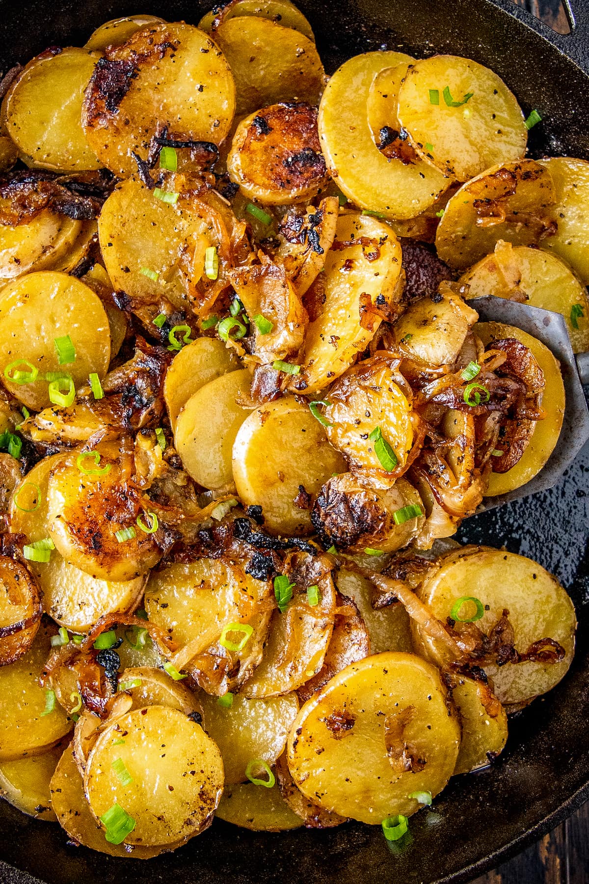 fried potatoes with onions in a skillet