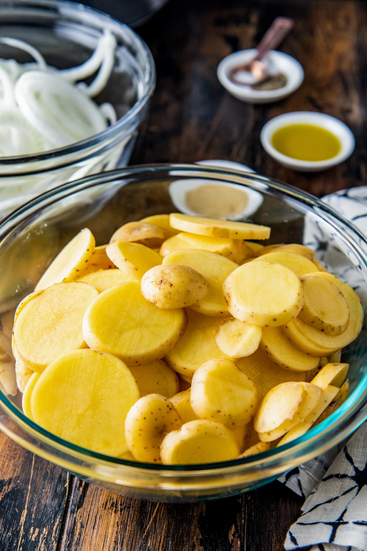 a bowl of sliced raw potatoes