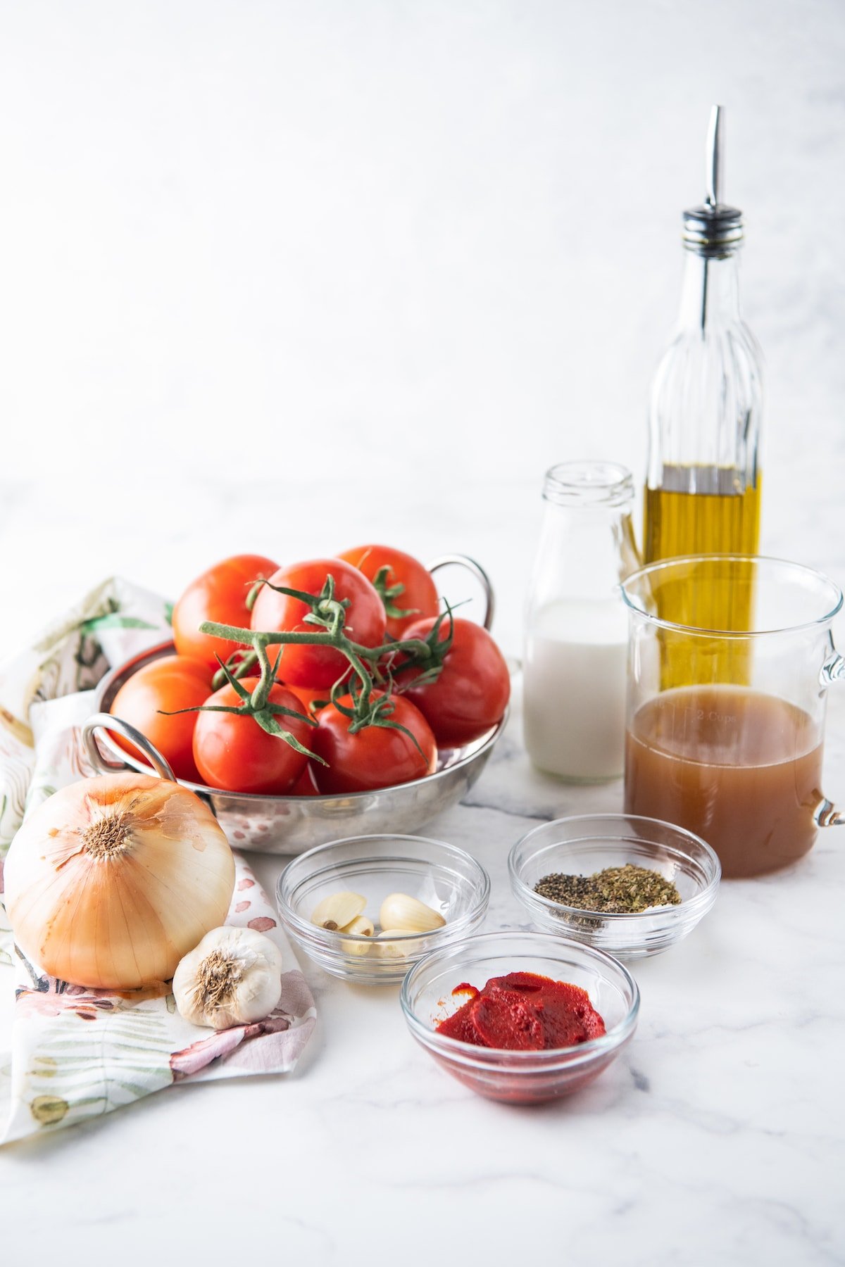 ingredients to make tomato soup like a tomatoes, onions, garlic, salt, pepper, broth, and olive oil