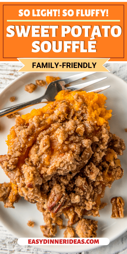 A white plate with a serving of sweet potato souffle with a fork.
