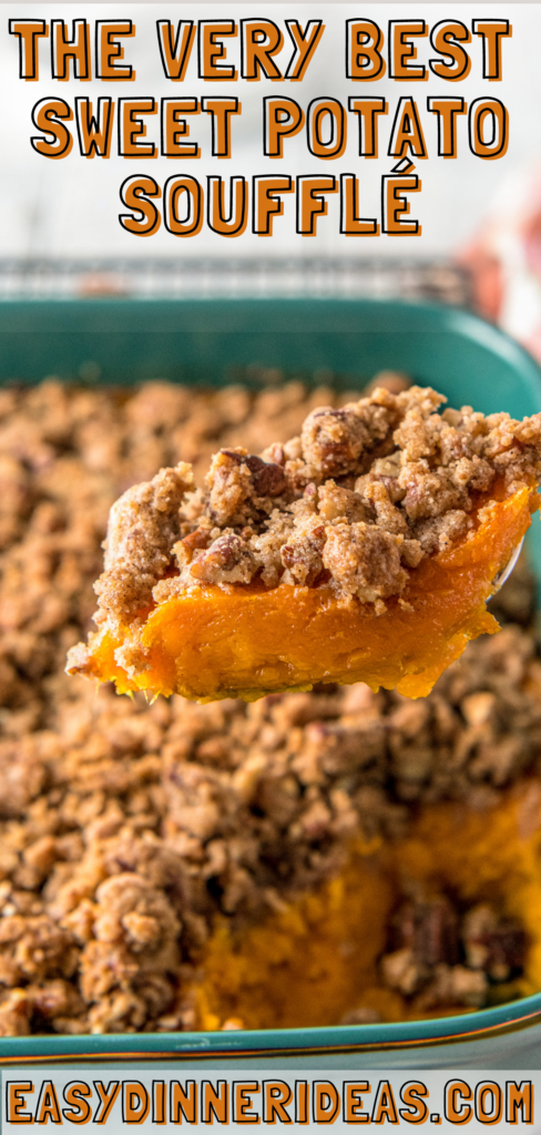 A serving spoon scooping up a serving of sweet potato souffle out of a casserole dish.