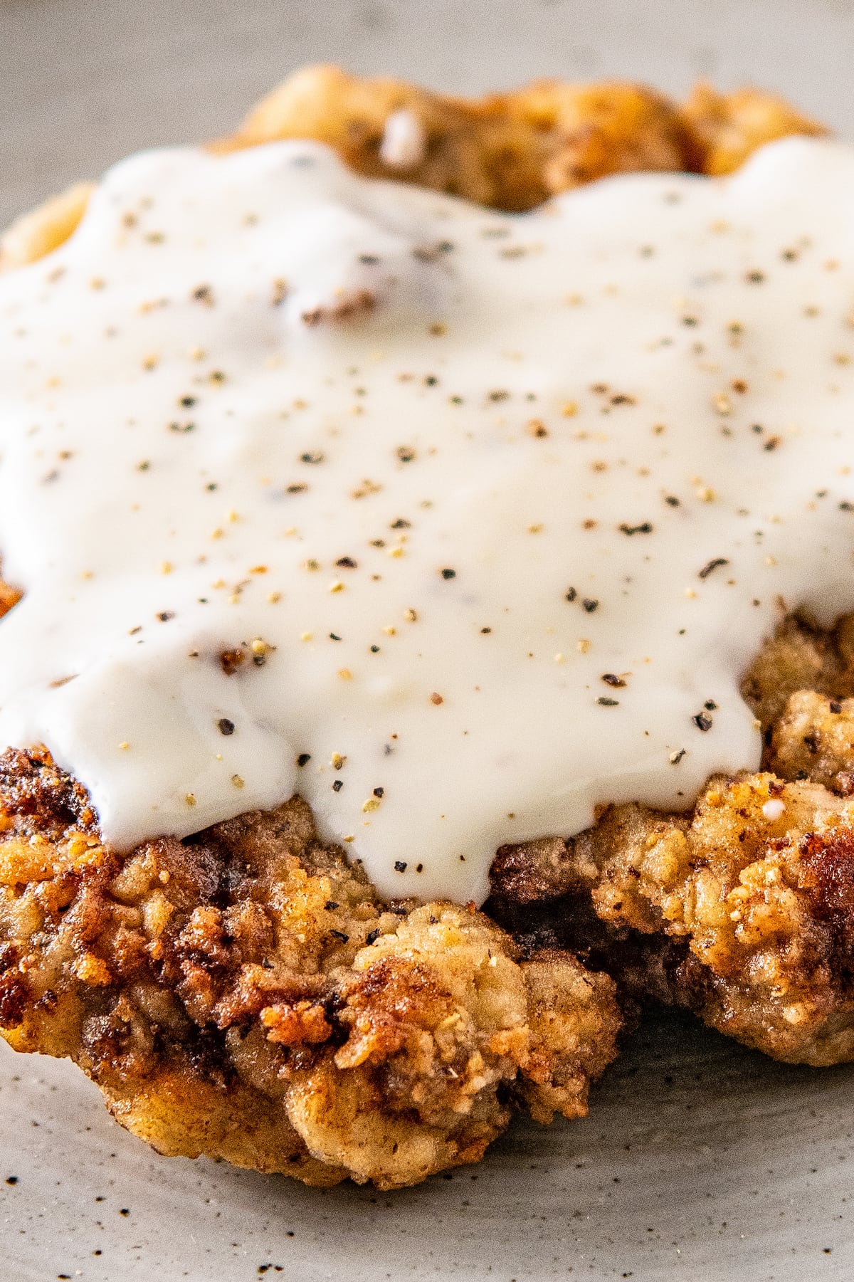 country gravy on top of chicken fried chicken