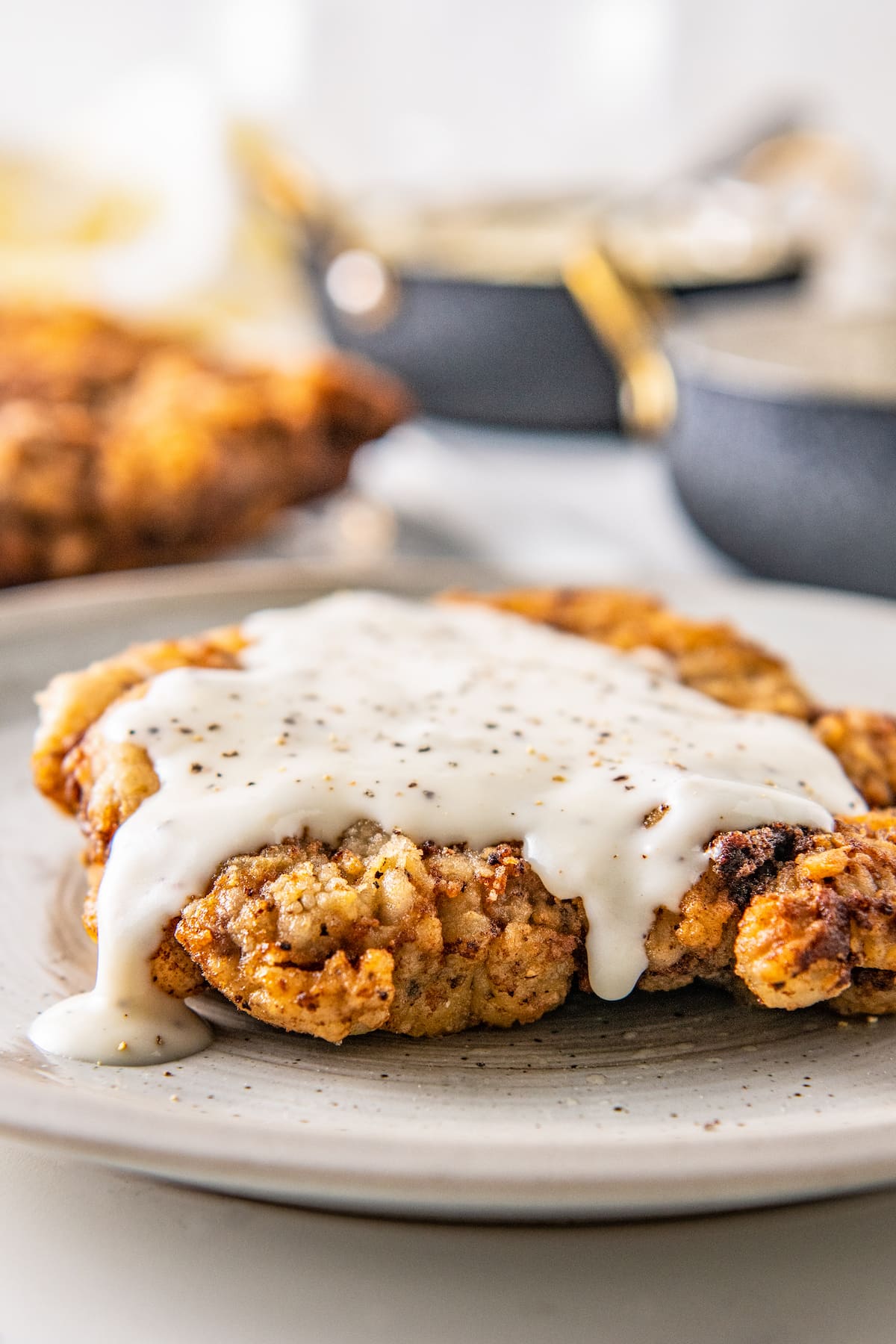 country gravy on top of chicken fried chicken