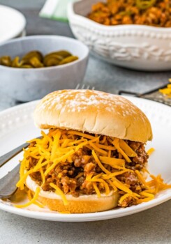 Crockpot Sloppy Joe sandwich with beef, meat sauce, and shredded cheese
