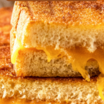 Air fryer grilled cheese cut in half and stacked on top of each other.