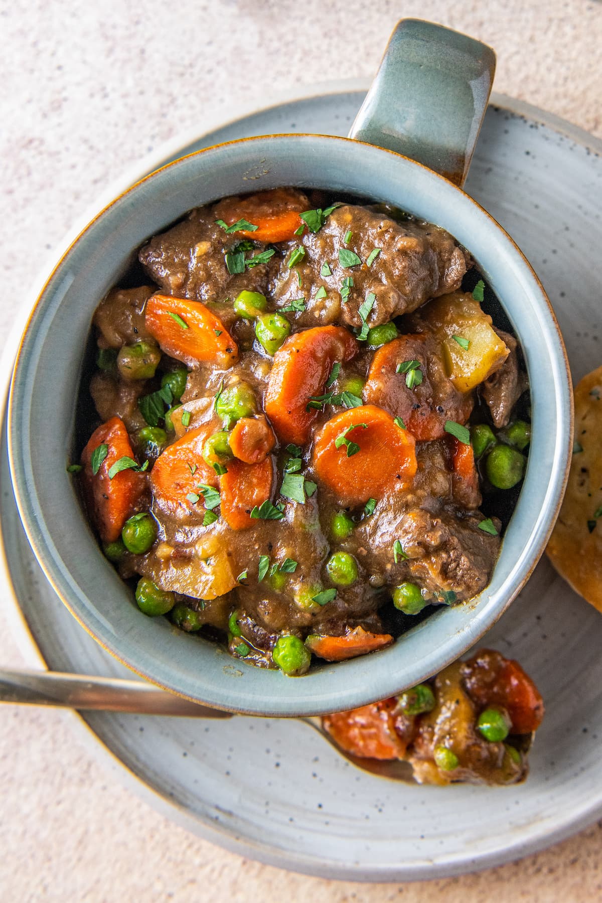 a bowl of beef stew with carrots and potatoes