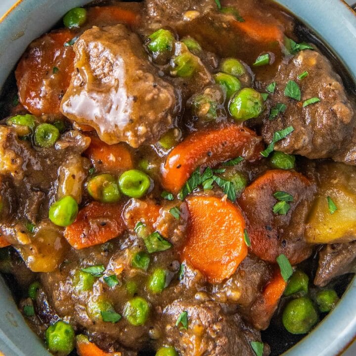 a bowl of beef stew with carrots and potatoes