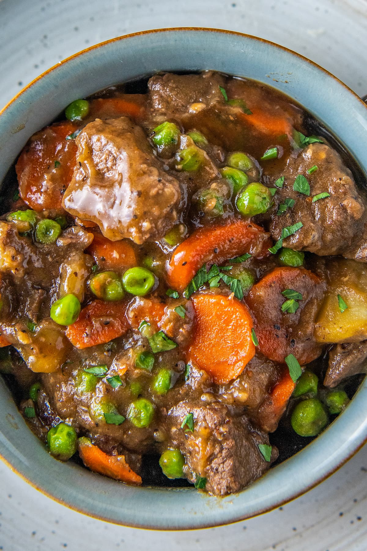 a bowl of beef stew with carrots and potatoes