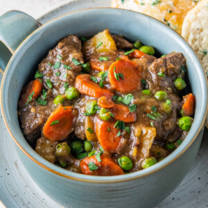 a bowl of beef stew with carrots and potatoes