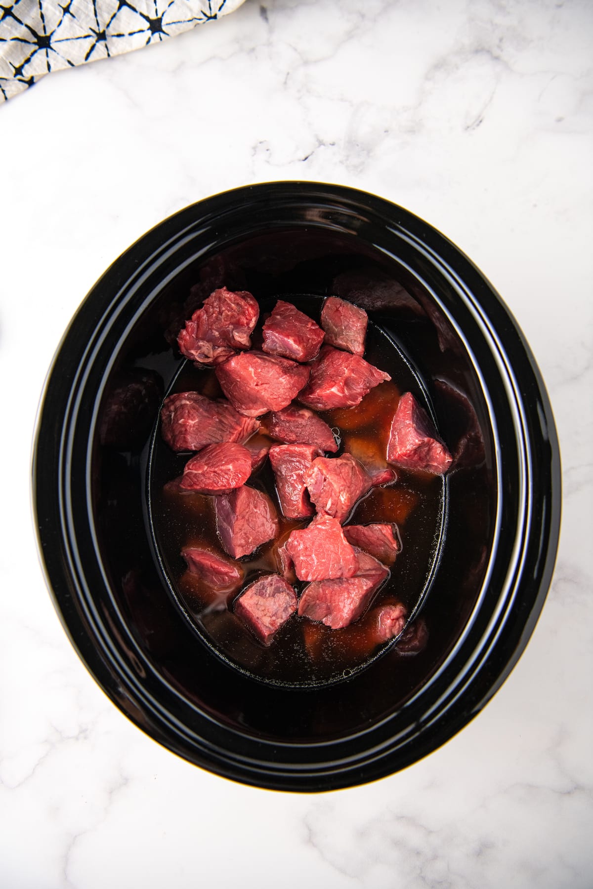 chunks of raw beef in a crock pot