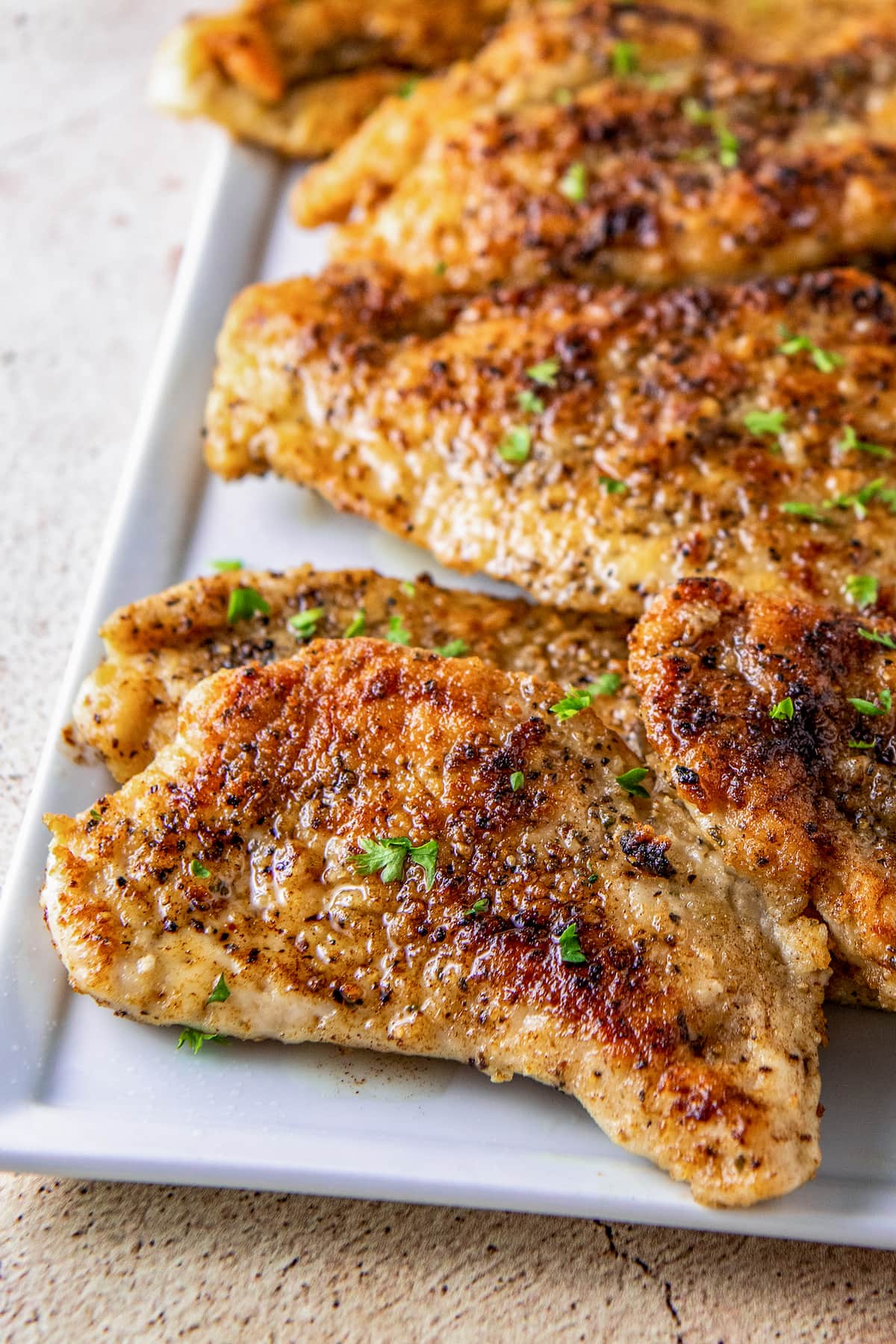 pan seared chicken breasts on a platter