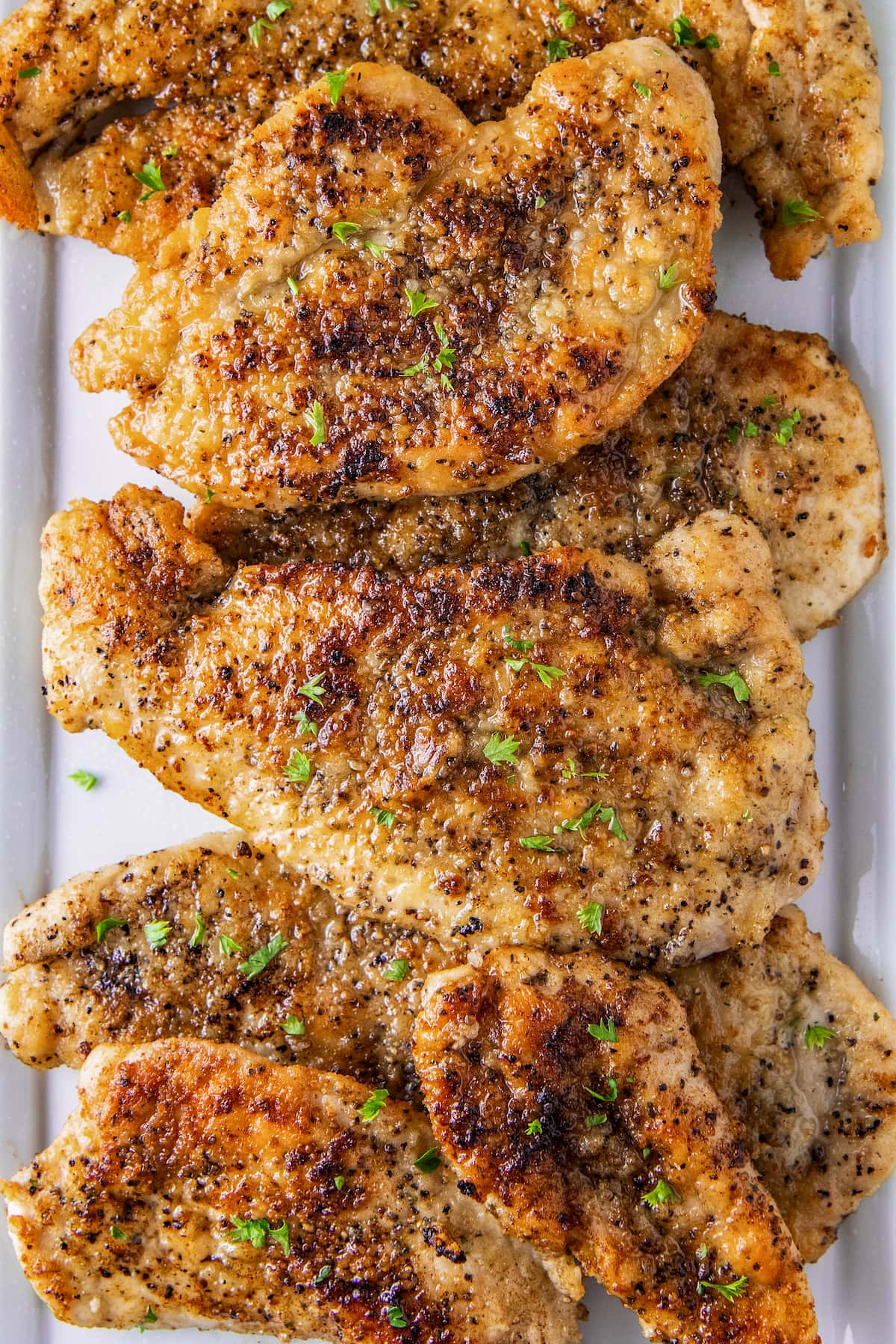 pan fried chicken breasts on a platter