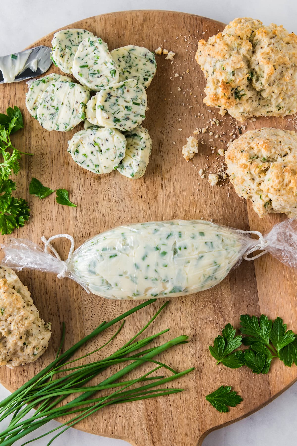 a rolled up log of garlic herb butter rolled in plastic