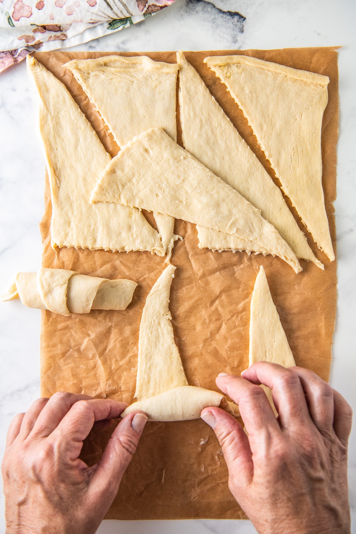 rolling up the dough to create crescent rolls