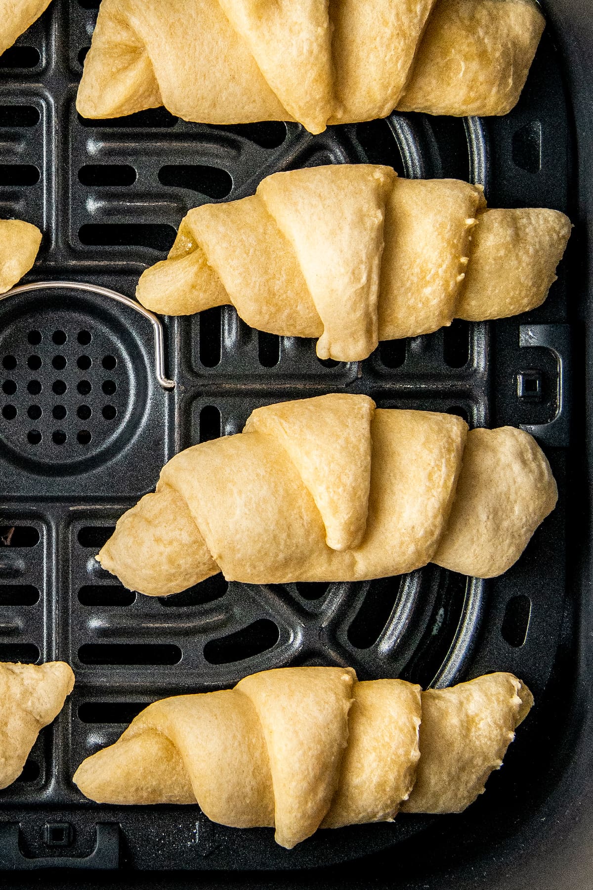 crescent rolls in an air fryer tray