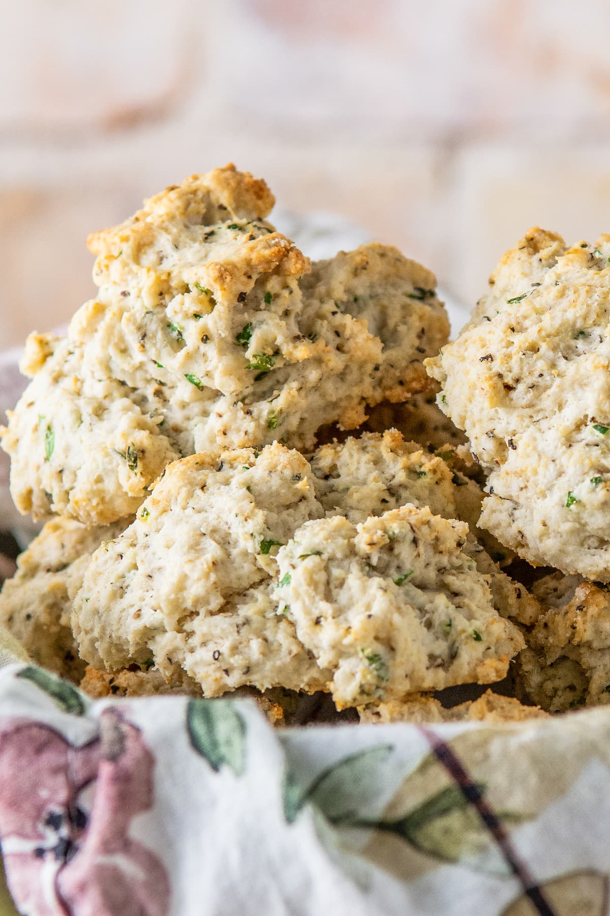 baked herb biscuits in a bowl with a tea towel